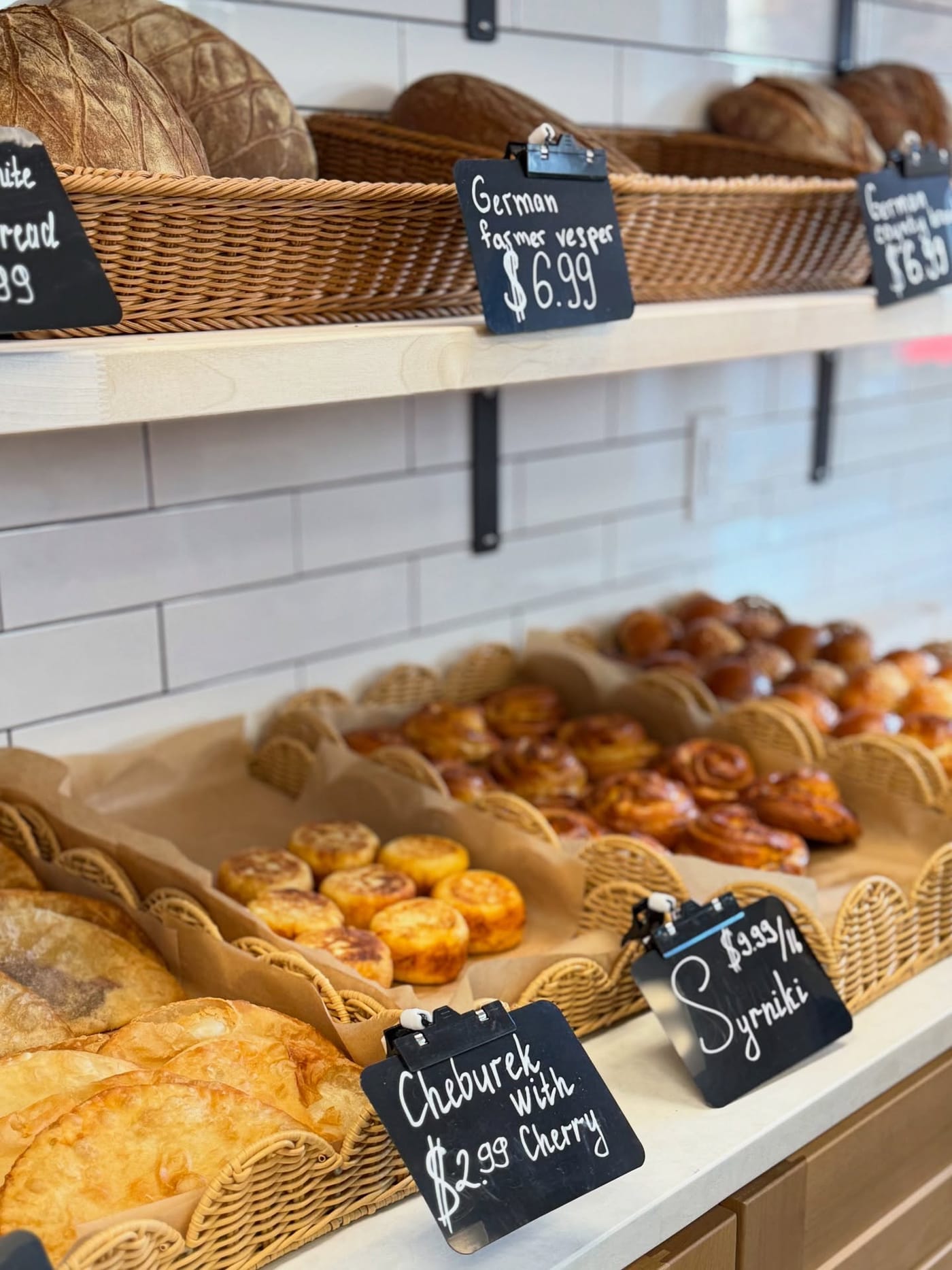 Delikat bakery counter — fresh pastries, breads, and pirozhki